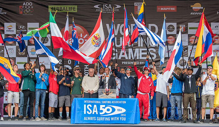 Current ISA President Fernando Aguerre (center), joined by the first ISA President, Peruvian Eduardo Arena, who founded the ISA in 1964, amongst the flags of the 22 National Teams, declared the Claro ISA 50th Anniversary World Surfing Games officially open. Photo: ISA/Michael Tweddle